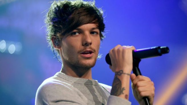 Breaking: Louis Tomlinson arrested for attacking a photographer