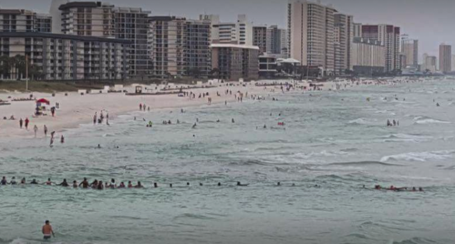 80 people form human chain to rescue family trapped in riptide
