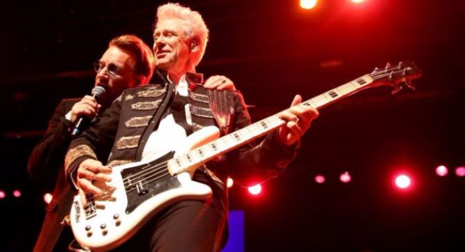 Bono tells concert crowds Adam Clayton and his wife are expecting