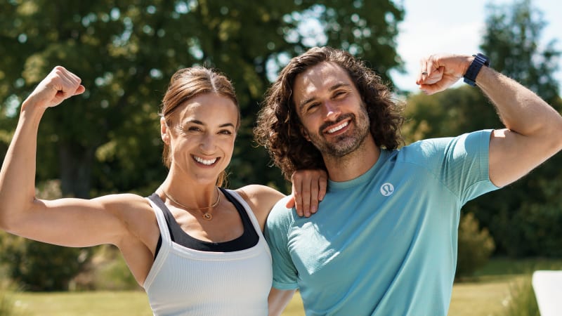 Joe and Rosie Wicks flexing their biceps and smiling outdoors at WellFest 2026