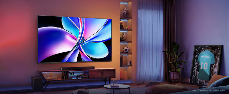 Large TV mounted above wooden media console in modern living room with purple ambient lighting and built-in shelving