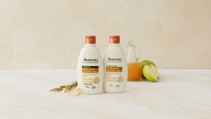Aveeno Clarify & Shine Apple Cider Vinegar Blend shampoo and conditioner duo with oats and green apples.
