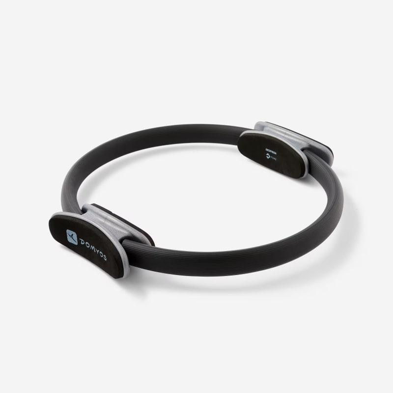 Domyos black Pilates ring with two oval foam handles, shown on a white background.