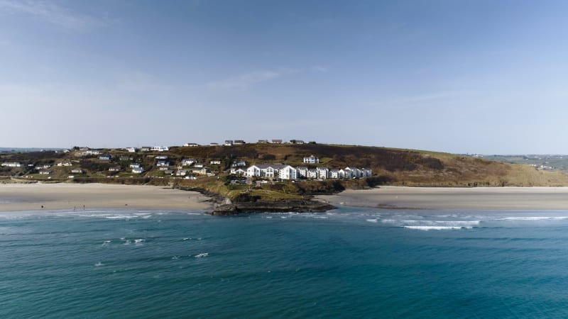 Aerial view of Inchydoney Island Lodge and Spa on a rocky headland between two sandy beaches in Ireland.