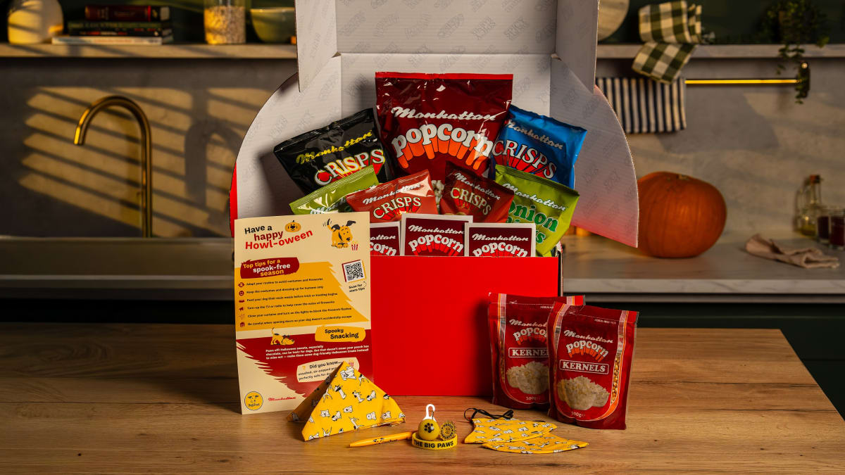 Manhattan and Dogs Trust Halloween gift box with crisps, popcorn, kernels, dog bandana, bell tag and Howl-oween leaflet.